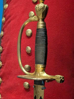 The handle of an ornate shortsword.