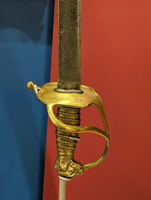 The golden crossbar of a saber.